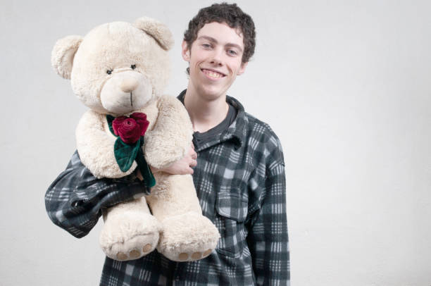 istock Young man holding a  teddy bear 1431191266