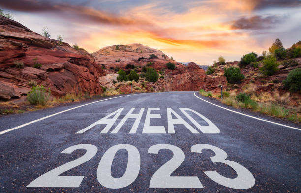 istock New Year 2023 ahead - empty road at sunrise 1431195456