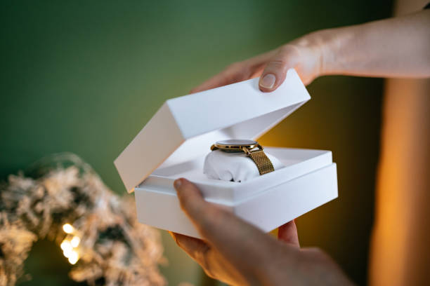 istock An Anonymous Woman Opening Christmas Present At Home 1431196355