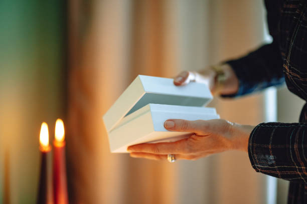 istock Unrecognizable Woman Opening Christmas Present At Home 1431196521