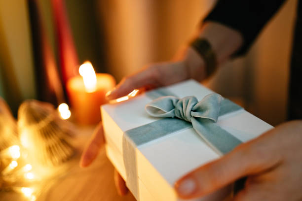 istock An Anonymous Woman Holding Christmas Present At Home 1431196528