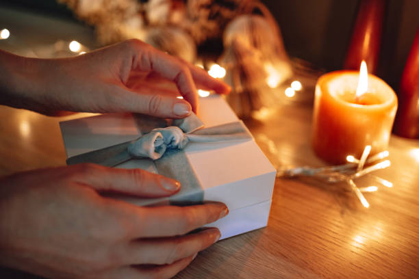 istock Unrecognizable Woman Opening Christmas Present At Home 1431196541