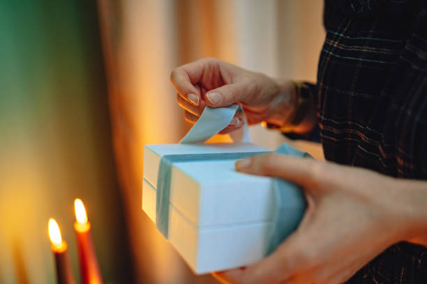 istock An Anonymous Woman Opening Christmas Present At Home 1431196552