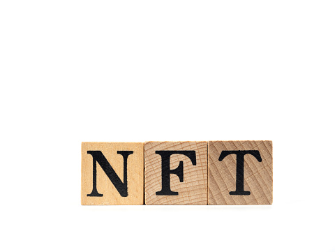 NFT Word on Wooden Cubes on White Background
