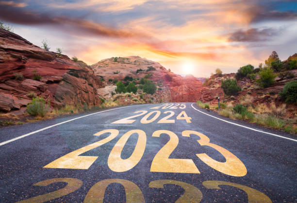 New Year 2023 road with sunrise and upcoming years ahead stock photo