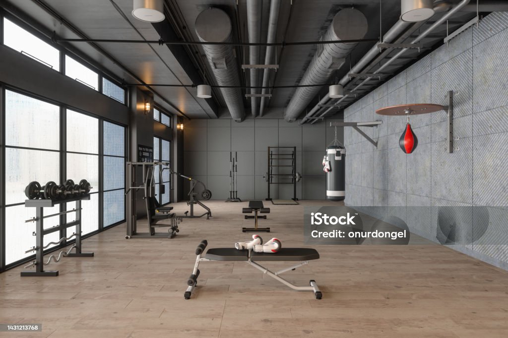 Modern Gym Interior With Boxing Bag, Workout And Training Equipments Gym Stock Photo