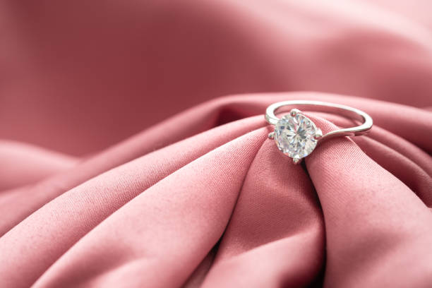 istock The wedding diamond ring is placed on a pink gold cloth. 1431216342