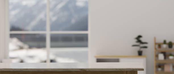 istock Empty space on tabletop over blurred minimal white living room in the background. 1431218610