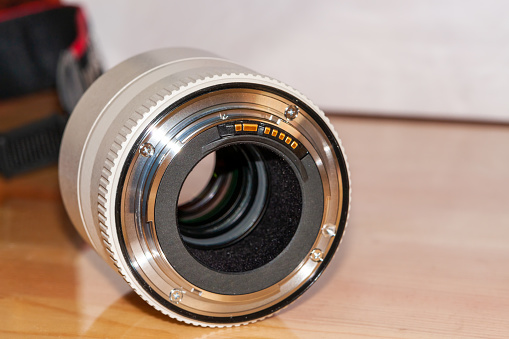 The m42 model is an analog camera lens used in the pre-digital age. Close-up lens photo taken in a light box with a white background.