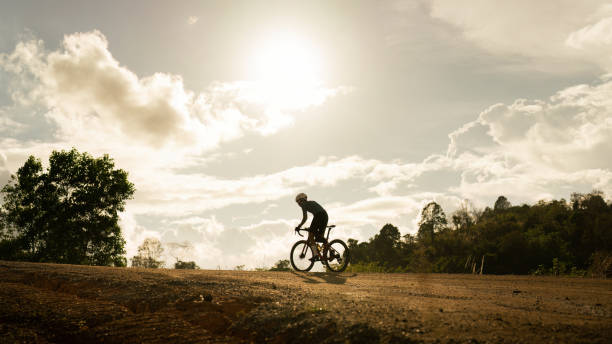 Cyclists practicing on gravel roads stock photo