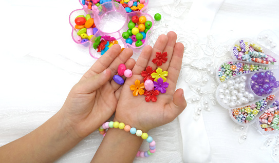 Set of multi-colored beads for needlework, child making jewelry at home. Easy and creative craft for children and teenagers