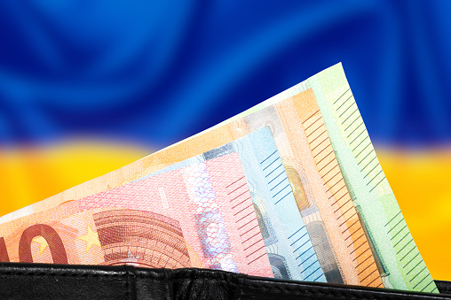 Flag of Ukraine and wallet with euro banknotes