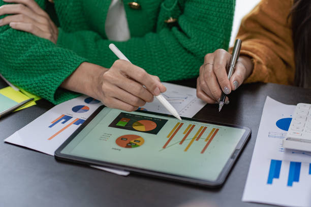 istock Businessman analyzing financial statistics displayed on a tablet screen. Business colleagues working and analyzing financial numbers on digital tablets. 1431223815