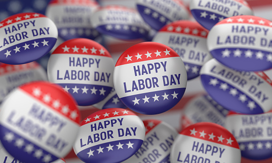 Badges with Labor Day writing on the American flag.