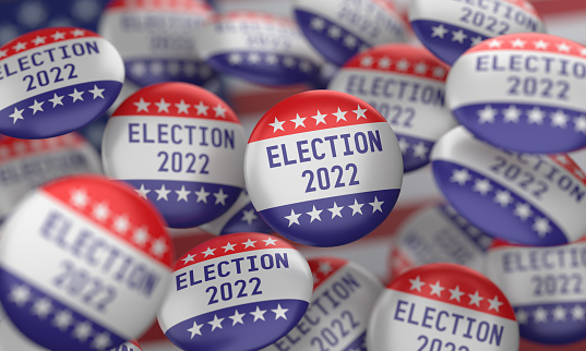 Badges with 2022 Election writing on the American flag.