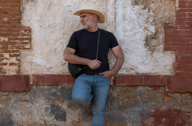 Free Stock Photo of Man Wearing Red Hat Standing in Front of Wall ...