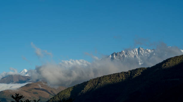 istock Snowcapped mountain ridge in clouds for a post card design 1431246548