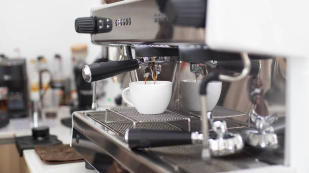 istock Barista makes artistic latte with espresso machine in cafe. Professional modern espresso coffee machine pours hot drink into the cup. Concept coffee in cafe. 1431247771