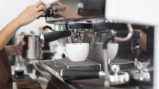 istock Barista makes artistic latte with espresso machine in cafe. Professional modern espresso coffee machine pours hot drink into the cup. Concept coffee in cafe. 1431247772