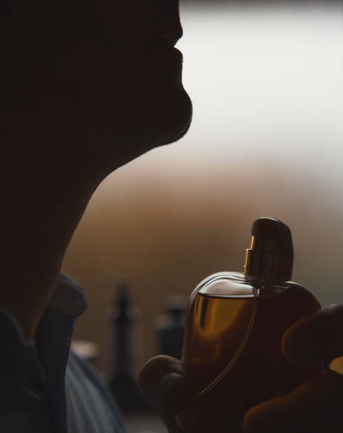 istock Man applying cologne eau de toilette on neck 1431250348