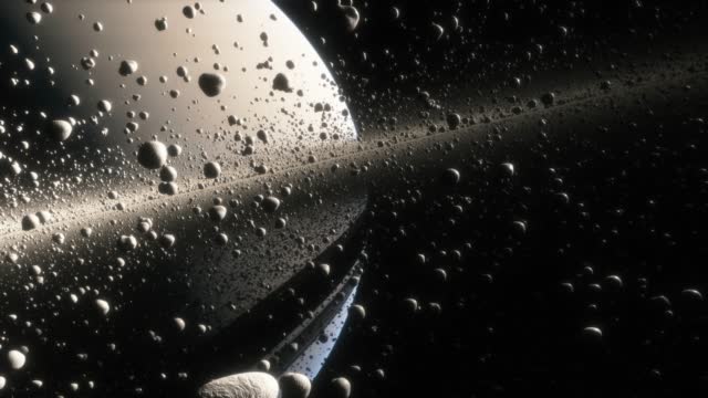 Cinematic animation of Saturn's rings made of rocks, dust and ice. Planet Saturn is a huge planet of the solar system with beautiful rings. Asteroid field near the planet