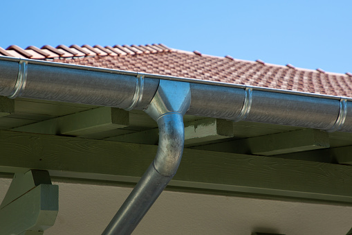 zinc gutter silver and pipe house construction new gray metal tile roof with gray rain gutters