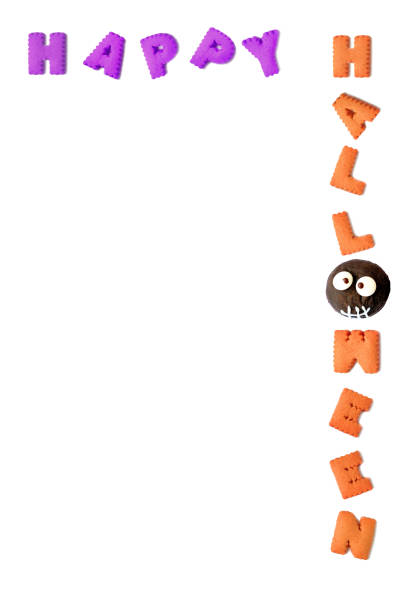 istock HAPPY HALLOWEEN typography made with alphabet cookies and chocolate ghost bun on white background 1431265047