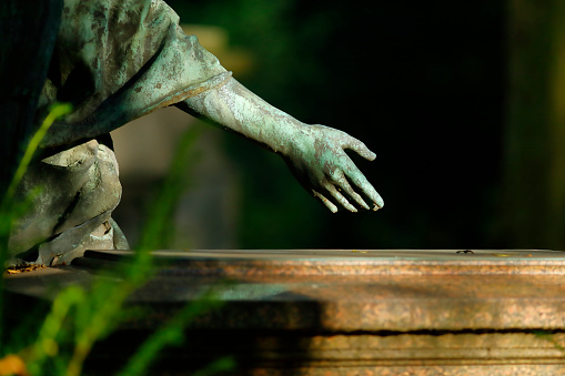 Hand of a Jesus Christ statue in a cemetery