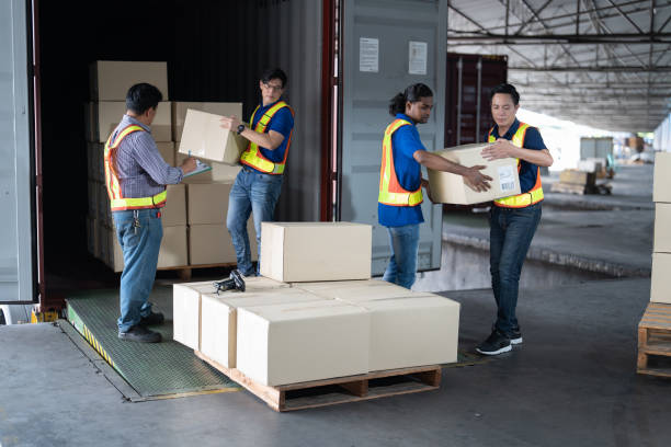 istock 4 men Warehouse worker open doors steel 40 feet container and help carry box one by one supervisor stand near by using paper clip checklist 1431269179