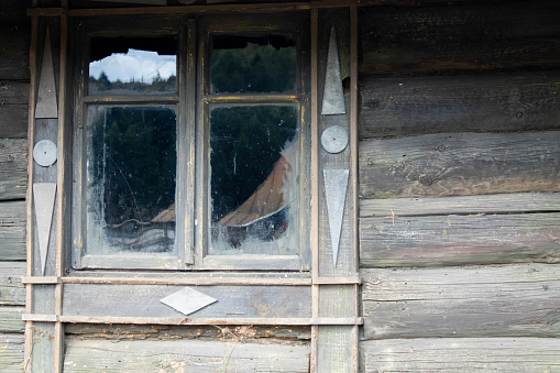Old wooden window with damaged glass