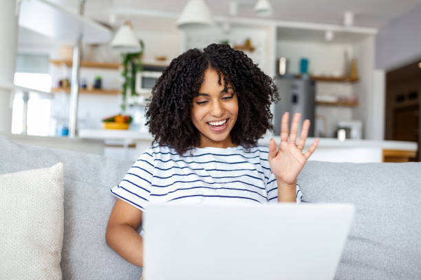istock Smiling woman work online on computer at home greet wave talk speak on video call on device. Happy female use laptop have webcam video virtual event with client or teacher. 1431277006
