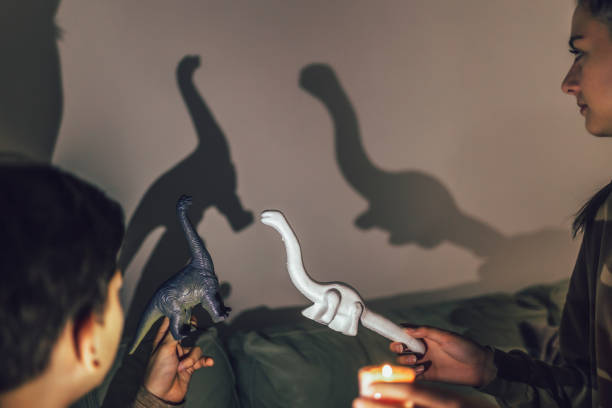 istock Brother and sister playing with shadows at home. 1431279598