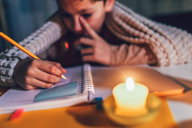 istock Little boy studying  with a burning candle. 1431279945