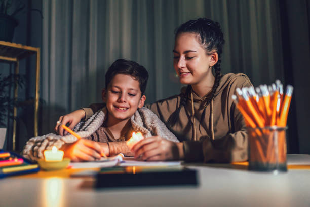 istock Boy and girl studying with a burning candle. 1431280019