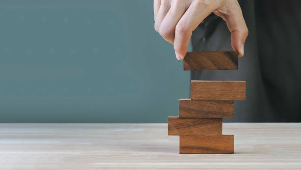 istock Hand arranging wood block stacking on top with white background. Business concept for growth success process 1431282053