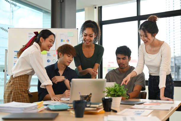 istock Group of startup business people in dressed casually brainstorming and working on new project at creative office. 1431286353