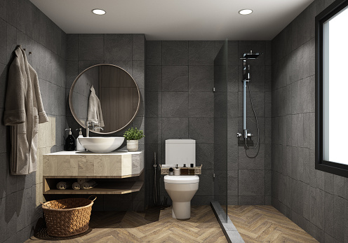 hotel bathroom toilet with dark gray stone tile walls, wood floor, Shower near the window and sink on wooden countertop with round mirror. with wooden decoration 3d rendering