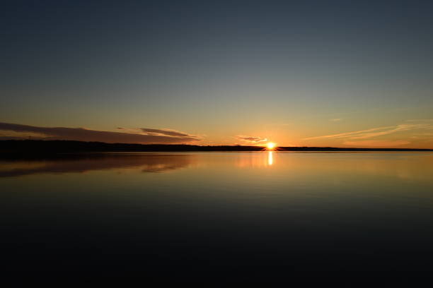istock Autumn sunset landscape  in sunny blue sky over reflective water surface 1431289390