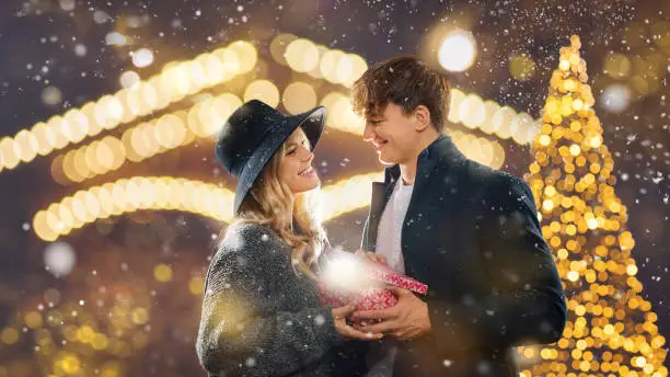 Photo of Couple outdoor in winter.  christmas - a couple celebrates together at the christmas market