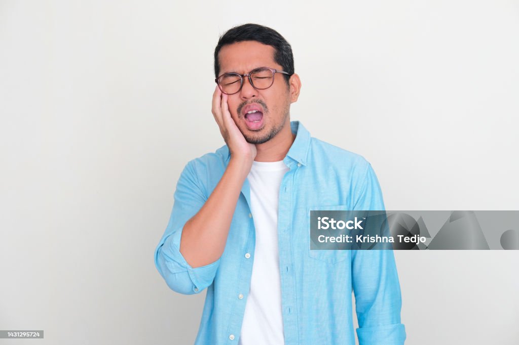 Adult Asian man touching his jaw with pain expression 35-39 Years Stock Photo
