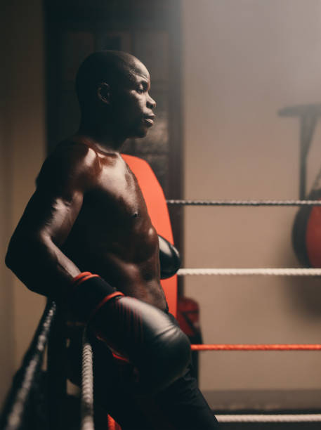 istock Shirtless young boxer taking a break in a boxing ring 1431296550