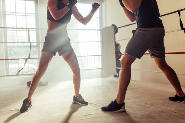 istock Low angle view of two young boxers fighting in a boxing ring 1431297044