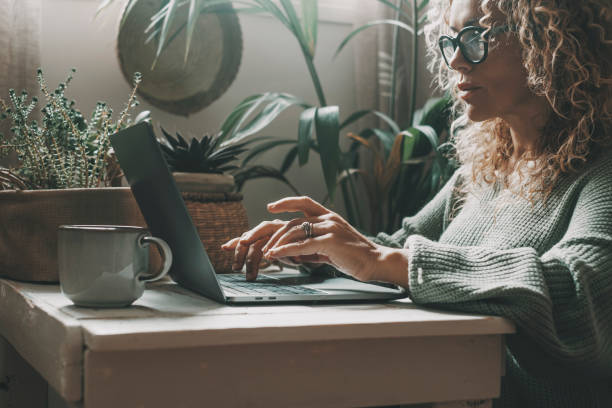 istock Professional woman working at home on laptop writing with concentrated expression. Modern female people using computer in indoor online leisure activity. Shopping or business smart work job freelance 1431297097