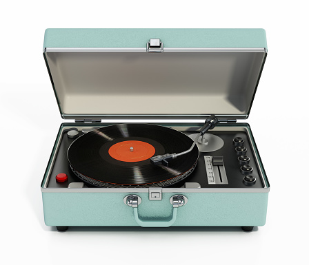 Portable analogue record player or turntable on retro style table.