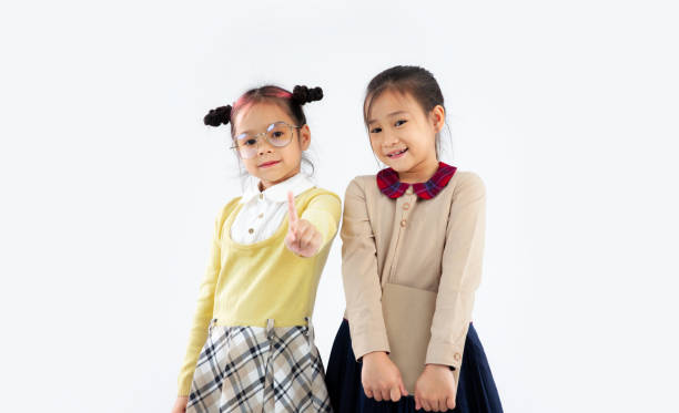 istock Junior asian schoolgirl posing on white background. Back to school primary student concept. 1431298078