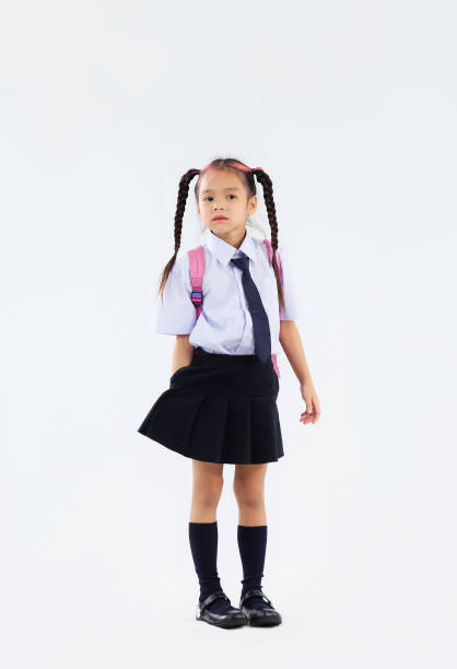 istock Back to school, junior school student in british uniform full length on white background. 1431298171