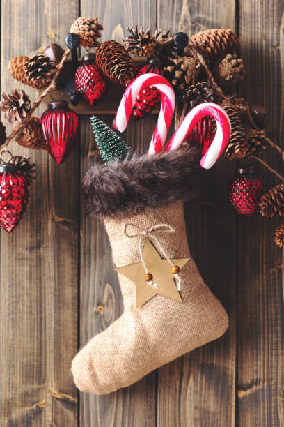 istock Christmas sock with christmas decorations on wooden wall. 1431300519