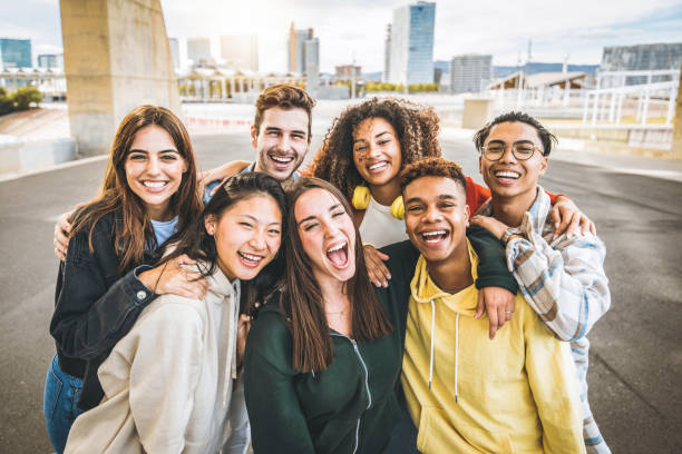 multiracial group of friends taking selfie picture outdoors - millennial people having fun on city street - international students smiling together at camera - youth culture and community concept - generatie z stockfoto's en -beelden