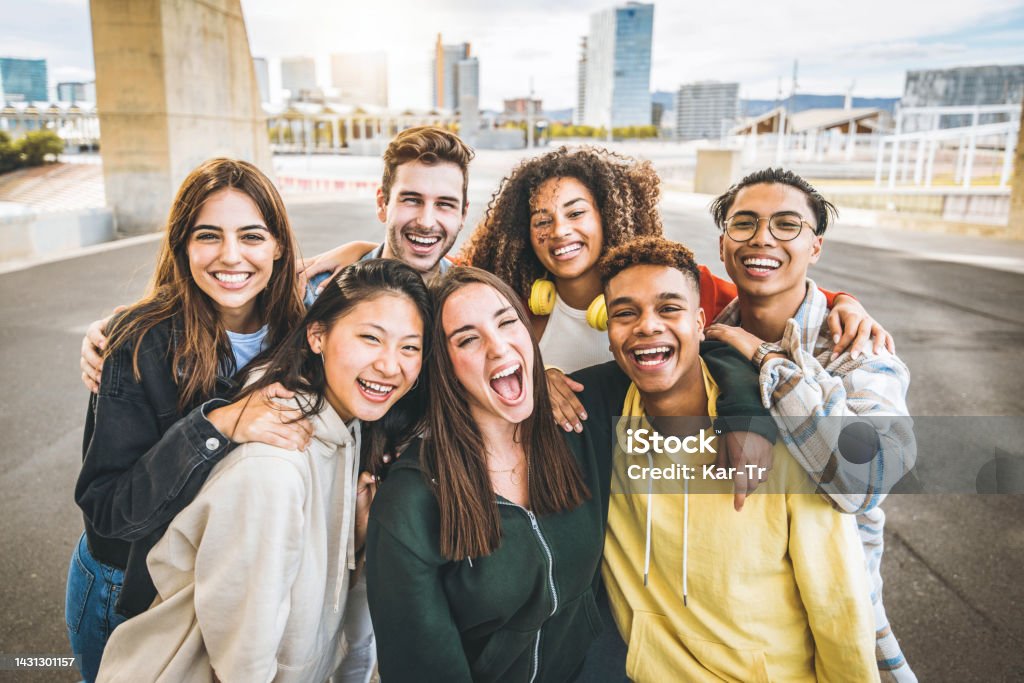 Multiracial group of friends taking selfie picture outdoors - Millennial people having fun on city street - International students smiling together at camera - Youth culture and community concept Teenager Stock Photo