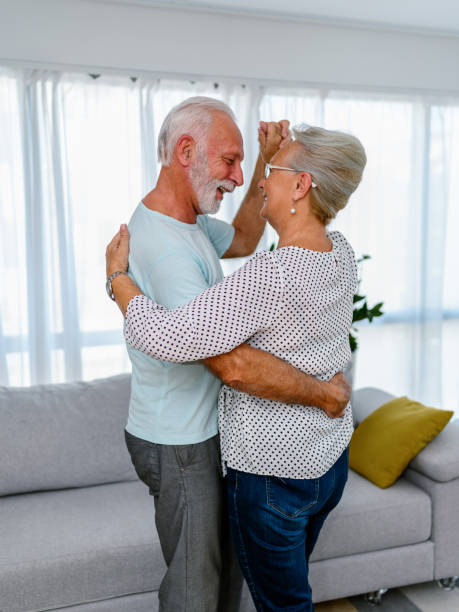 istock Senior couple dancing at home 1431303426